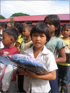 Child receiving a school uniform